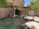 Green backyard with stepping stones leading to the side gate and garden at 9018 W Superior Ave, Tolleson, AZ 85353