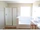 Bathroom featuring a separate shower and bathtub with natural light at 9018 W Superior Ave, Tolleson, AZ 85353