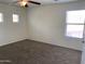 Bedroom featuring neutral carpet, three windows with blinds, and ample space at 9018 W Superior Ave, Tolleson, AZ 85353