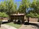 Charming home with mature trees, lush landscaping, and well-manicured lawn creates a welcoming curb appeal at 9018 W Superior Ave, Tolleson, AZ 85353
