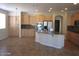 Open kitchen with a breakfast bar, light wood cabinets, granite counters, and stainless steel appliances at 9018 W Superior Ave, Tolleson, AZ 85353