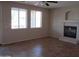 Spacious living room with tile floors, a modern fireplace, and natural light at 9018 W Superior Ave, Tolleson, AZ 85353