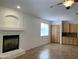 View of living room with a fireplace and kitchen with light wood cabinets and granite countertops at 9018 W Superior Ave, Tolleson, AZ 85353