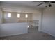 Carpeted loft area featuring natural light and wrought iron railing at 9018 W Superior Ave, Tolleson, AZ 85353