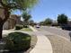 Picturesque suburban street view showcases well-maintained homes, lush landscaping, and tranquil neighborhood charm at 9018 W Superior Ave, Tolleson, AZ 85353
