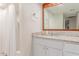Bathroom featuring a granite countertop vanity, framed mirror and shower with white curtain at 930 S Dobson Rd # 3, Mesa, AZ 85202