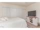 Bright bedroom with ceiling fan, sliding closet and modern entertainment center at 930 S Dobson Rd # 3, Mesa, AZ 85202