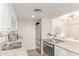 Kitchen with stainless steel appliances, white cabinets, granite counters, and view into dining area at 930 S Dobson Rd # 3, Mesa, AZ 85202
