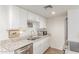 Bright kitchen featuring white cabinets, stainless steel appliances, granite countertops, and modern faucet at 930 S Dobson Rd # 3, Mesa, AZ 85202