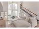 Bright living room showcasing modern fireplace, staircase to loft, large windows, and comfortable neutral furniture at 930 S Dobson Rd # 3, Mesa, AZ 85202
