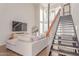 Bright living room showcasing modern fireplace, staircase to loft, large windows, and comfortable neutral furniture at 930 S Dobson Rd # 3, Mesa, AZ 85202