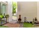 Private patio featuring artificial turf, stylish decor, and convenient access to adjacent neighborhood area at 930 S Dobson Rd # 3, Mesa, AZ 85202