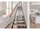 Modern staircase with metal railings, wood treads, and view of the living area at 930 S Dobson Rd # 3, Mesa, AZ 85202