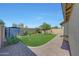 Fully fenced backyard featuring stone-paved area and shed in the corner at 9926 W Gross Ave, Tolleson, AZ 85353