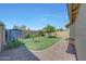 Fully fenced backyard featuring stone-paved area and shed in the corner at 9926 W Gross Ave, Tolleson, AZ 85353