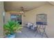 Cozy covered patio featuring comfortable seating area and birdcage at 9926 W Gross Ave, Tolleson, AZ 85353