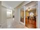 Inviting entryway with neutral tile flooring that leads to a bright office space with hardwood flooring and an ample desk at 9926 W Gross Ave, Tolleson, AZ 85353