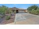 Charming front yard with desert landscaping and paved driveway leading to a two-car garage at 9926 W Gross Ave, Tolleson, AZ 85353