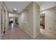 Spacious hallway featuring tile floors, neutral paint, and arched alcoves for decor at 9926 W Gross Ave, Tolleson, AZ 85353