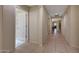 Inviting hallway featuring neutral walls, tiled floors, and archways for added elegance at 9926 W Gross Ave, Tolleson, AZ 85353
