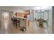 Bright kitchen and dining area featuring a breakfast bar, and a cozy dining nook near a bright window at 9926 W Gross Ave, Tolleson, AZ 85353