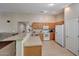 Functional kitchen with tile flooring, a breakfast bar, and standard appliances for everyday cooking needs at 9926 W Gross Ave, Tolleson, AZ 85353