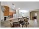 Open kitchen with breakfast bar and adjacent dining area featuring tile floors and pendant lighting above the table at 9926 W Gross Ave, Tolleson, AZ 85353