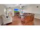 Cozy living room with hardwood floors, a fireplace, a ceiling fan, and comfortable leather seating for relaxing at 9926 W Gross Ave, Tolleson, AZ 85353