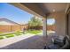 Expansive covered patio with views of the meticulously designed backyard with pavers and artificial grass at 10240 E Supernova Dr, Mesa, AZ 85212