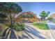 Community park entrance featuring mature trees, park benches, colorful playground, and a well-maintained path at 10240 E Supernova Dr, Mesa, AZ 85212