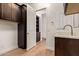 Convenient laundry room with modern washer/dryer, custom cabinets, and quartz countertop at 10240 E Supernova Dr, Mesa, AZ 85212