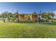 Picturesque outdoor stage area surrounded by lush green lawns and mature trees at 10240 E Supernova Dr, Mesa, AZ 85212