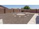Spacious backyard featuring decorative rock and a unique stone patio design, perfect for outdoor enjoyment at 10618 W Pima St, Tolleson, AZ 85353