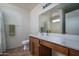 Well-lit bathroom featuring a wood vanity, large mirror, and a single sink at 10618 W Pima St, Tolleson, AZ 85353