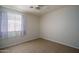 This bedroom features neutral walls, tile flooring, and a window that provides natural light at 10618 W Pima St, Tolleson, AZ 85353