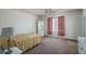 Bright bedroom featuring carpeted flooring, ceiling fan, and wardrobe cabinet at 10618 W Pima St, Tolleson, AZ 85353
