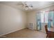 This bedroom features neutral walls, tile flooring, a window, and a built-in bookshelf at 10618 W Pima St, Tolleson, AZ 85353