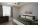 Comfortable bedroom with neutral walls, tile flooring, and ample natural light creates a relaxing atmosphere at 10618 W Pima St, Tolleson, AZ 85353