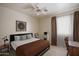 Comfortable bedroom with neutral walls, tile flooring, and ample natural light creates a relaxing atmosphere at 10618 W Pima St, Tolleson, AZ 85353