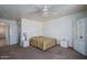 Bright bedroom with white walls, ceiling fan, carpet, and white furniture at 10618 W Pima St, Tolleson, AZ 85353