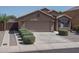 Home with an appealing two-car garage, complemented by tidy landscaping for enhanced curb appeal at 10618 W Pima St, Tolleson, AZ 85353