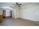 Bright and open living room featuring tile floors, a ceiling fan, and a large window at 10618 W Pima St, Tolleson, AZ 85353