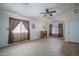 Bright living room with tile floors, ceiling fan, and neutral walls at 10618 W Pima St, Tolleson, AZ 85353