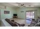 Bright living room featuring tile flooring, ceiling fan, and sliding glass doors to the backyard at 10618 W Pima St, Tolleson, AZ 85353