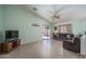 Spacious living room featuring tile flooring, neutral color, and sliding glass doors at 10618 W Pima St, Tolleson, AZ 85353