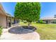 Backyard featuring a well-manicured lawn, landscaping, and a screened in porch at 10651 W Saratoga Cir, Sun City, AZ 85351