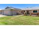 Beautiful single-story home with solar panels, charming porch, and verdant lawn at 10651 W Saratoga Cir, Sun City, AZ 85351