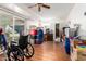 Bright living room featuring hardwood floors, a ceiling fan, and a wheelchair at 10651 W Saratoga Cir, Sun City, AZ 85351