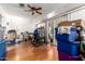 Living room featuring hardwood floors, fan, and sliding glass door leading to outside at 10651 W Saratoga Cir, Sun City, AZ 85351