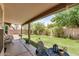 Spacious backyard featuring a covered patio area, lush green grass, and privacy fencing at 1330 W Butler Dr, Chandler, AZ 85224